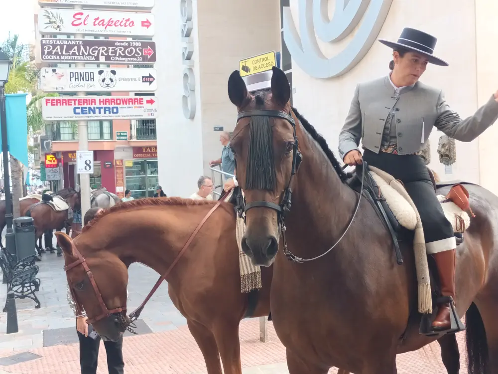 A woman dressed in a Spanish national costume on horseback