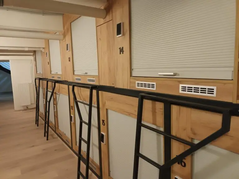 [:en]Capsule hotel where sleeping places are behind a small door in the wall.[:]