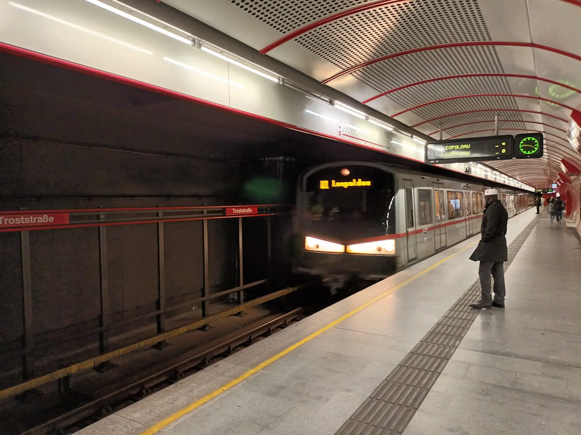 The metro train arrives at the station in the Vienna underground.