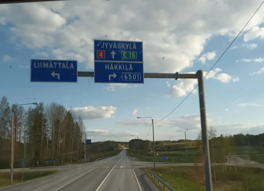 [:en]Traffic signs above the highway. Captured from the front window of the second floor of a double-decker bus.[:]