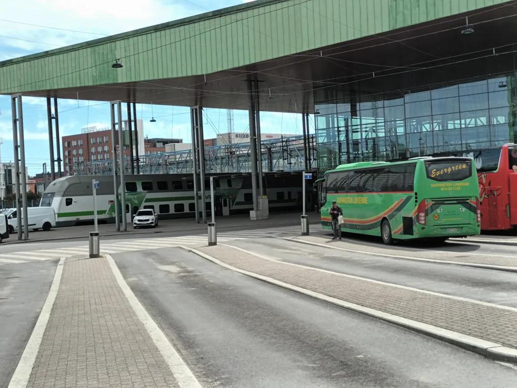 [:en]Jyväskylä travel center in Finland. Two buses and a train at the station.[:]
