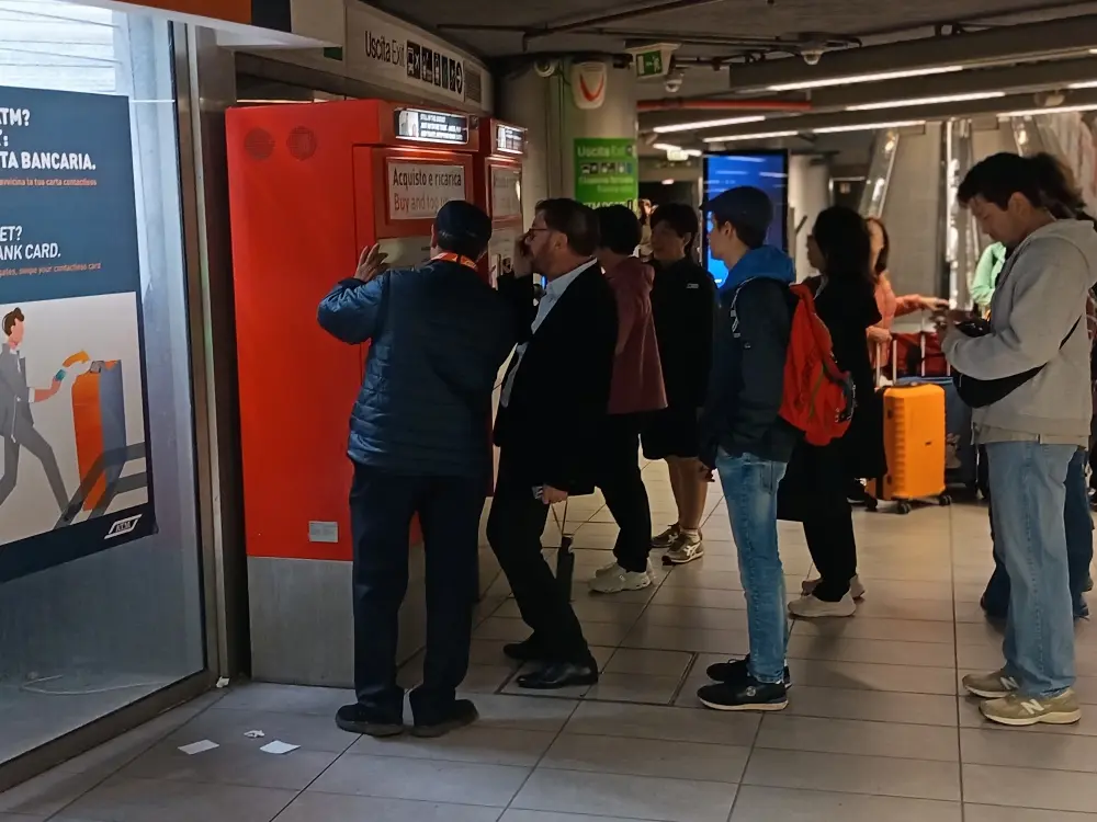 People at the ticket machine in the Milan metro