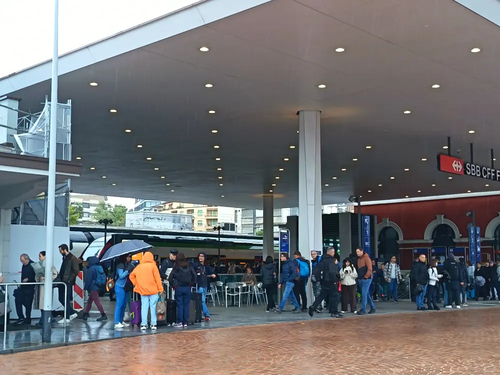 Lugano transport hub. People in the rain.