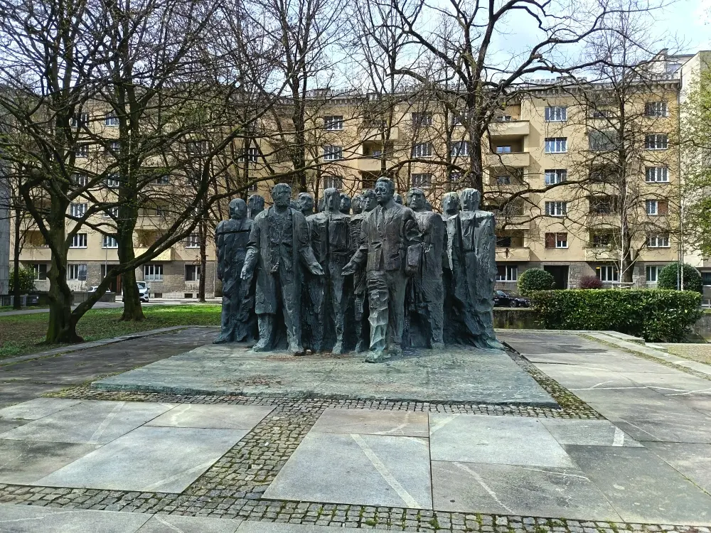 A statue in Ljubljana. It depicts a group of people.