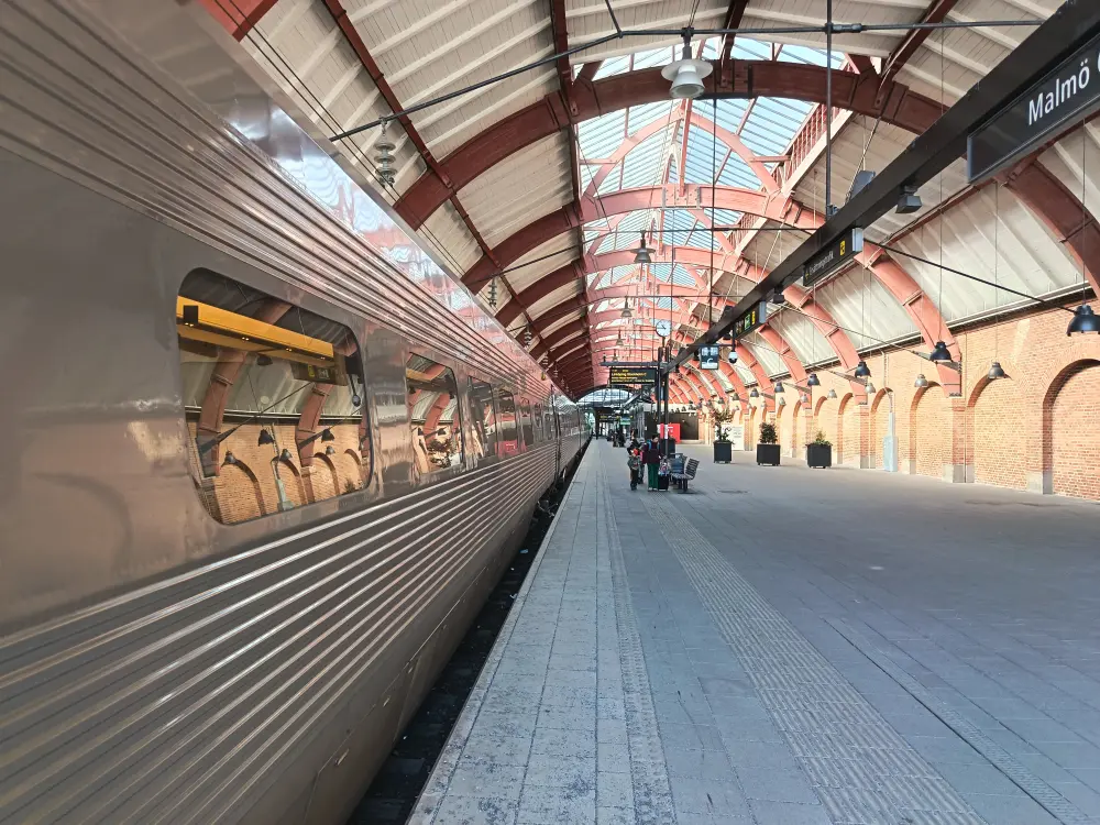 The train platform at Malmö train station and the train departing.