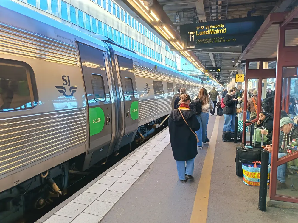 The train platform at Stockholm train station and passengers disembarking from the train.