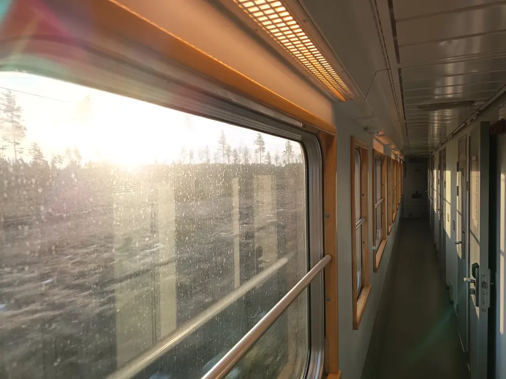 A morning landscape is visible in the corridor of the Stockholm-Lulea sleeping car on the train.