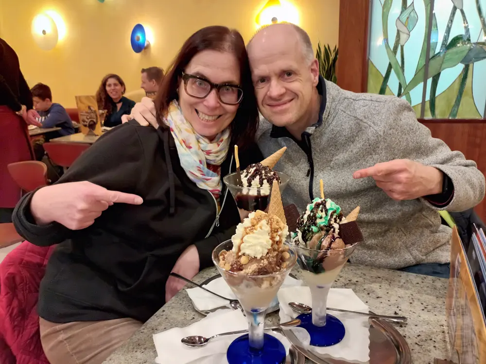 A woman and a man are in a restaurant about to start eating ice cream.