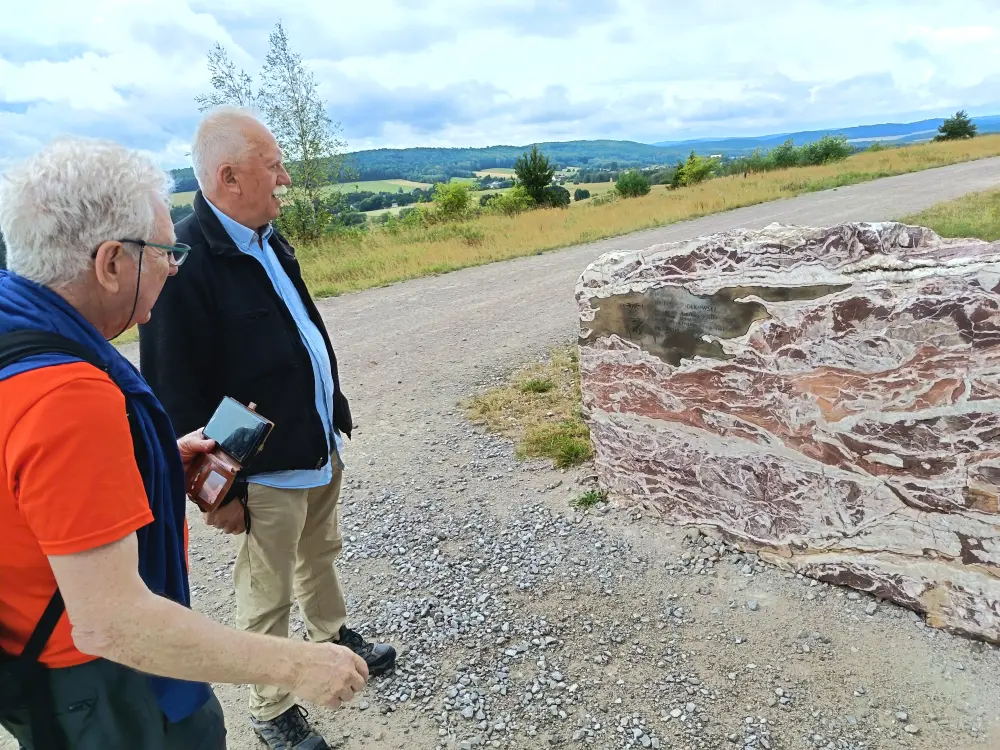 Amir Levy and Michal Olczak are looking at the marble stone.